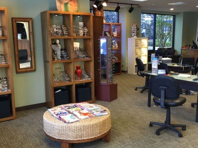 A wicker ottoman sits in the middle of a room