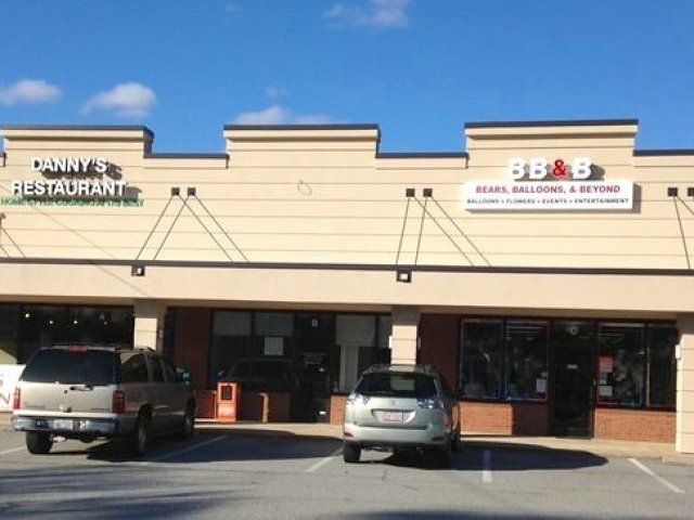 Two cars are parked in front of a canny 's restaurant