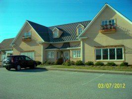 A car is parked in front of a house that was taken on 03/07/2012