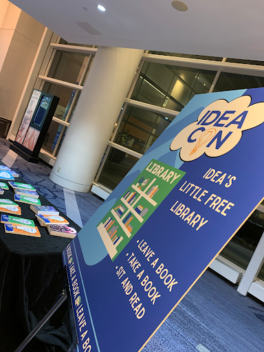 The IDEAcon IDEA’s Little Free Library sign next to the table for people to take a book, leave a book, or to sit and read.