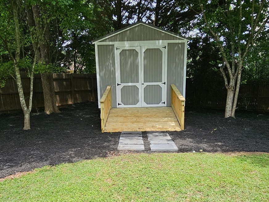 Two people inside a building under construction, examining the interior, the woman pointing at a window.