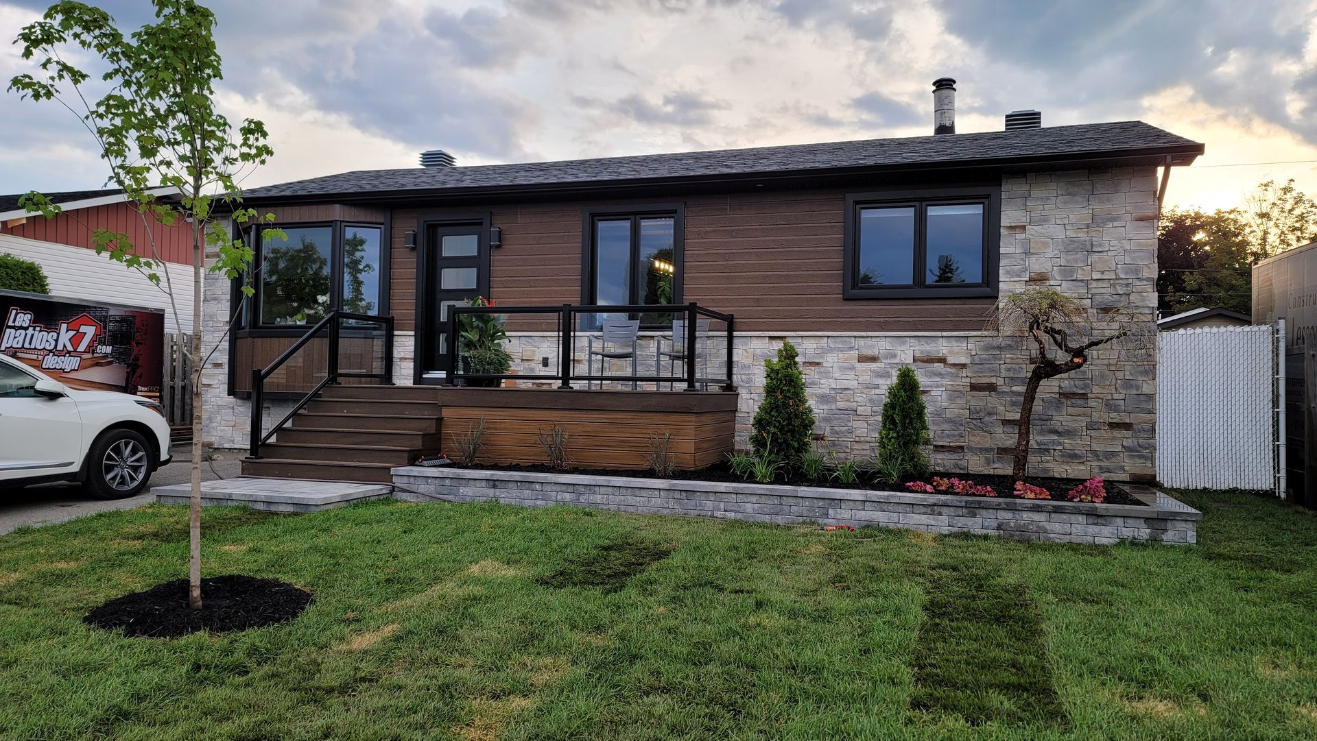 Une maison avec une voiture garée devant.