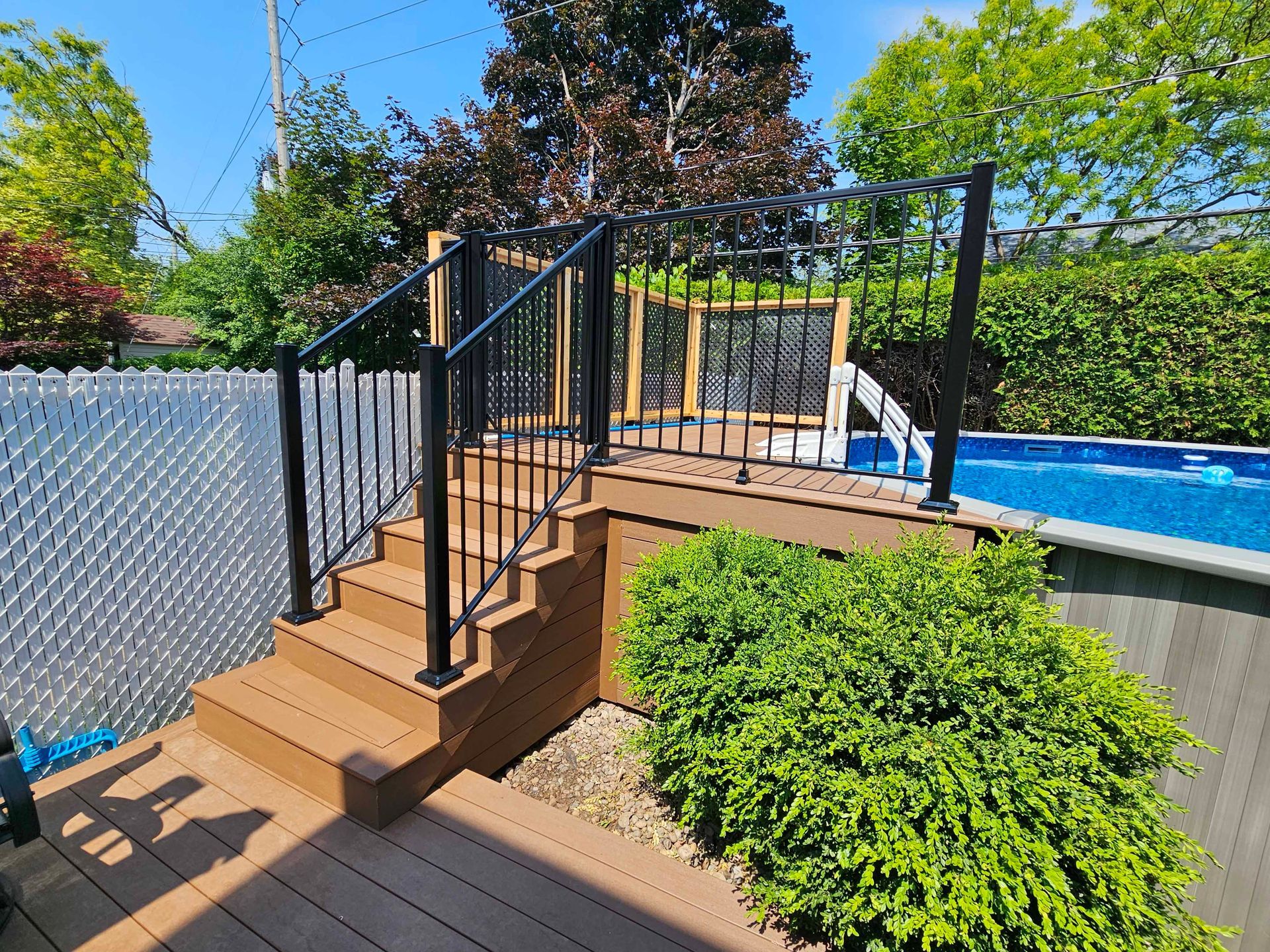 Une terrasse avec des escaliers menant à une piscine.