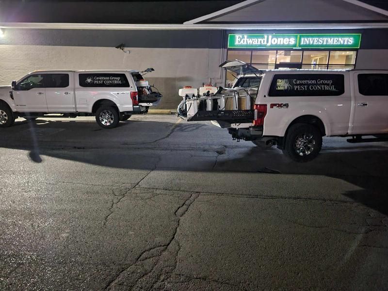 Two trucks are parked in front of a building that says edward jones investments