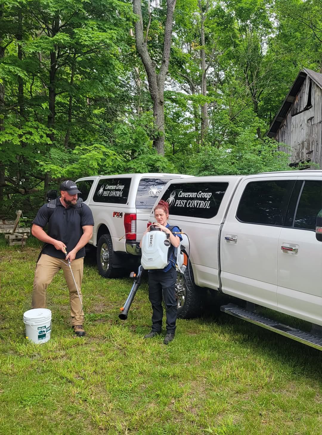 A man and a boy are standing in front of a row of trucks.