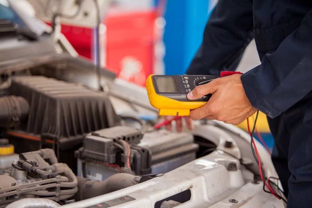 Mechanic Checking Car Battery — Ravenshoe Auto Electrical In Ravenshoe, QLD