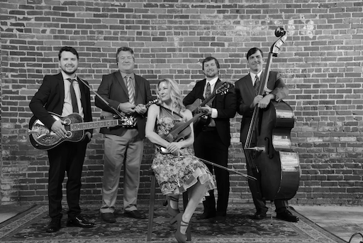 A man is sitting on the floor in a black and white photo.