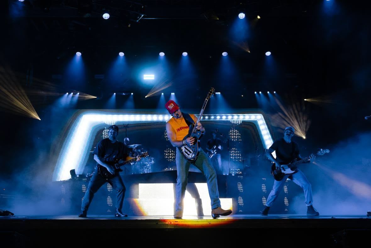 The eli young band is playing a concert in front of a crowd.