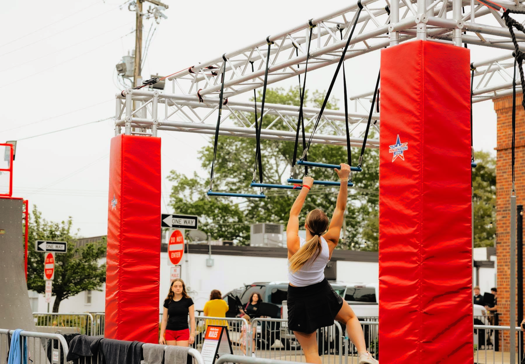 A woman is walking a dog on a leash on a stage in front of a crowd.