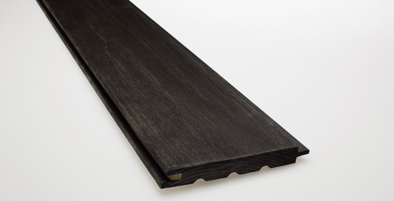 a piece of black wood is sitting on a white surface .