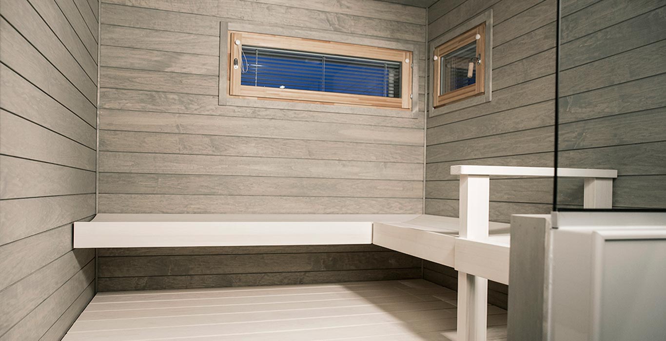 a bathroom with a window and a bench .