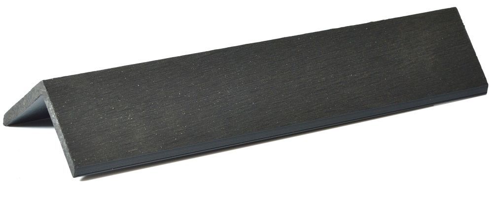 a black piece of wood is sitting on a white surface .