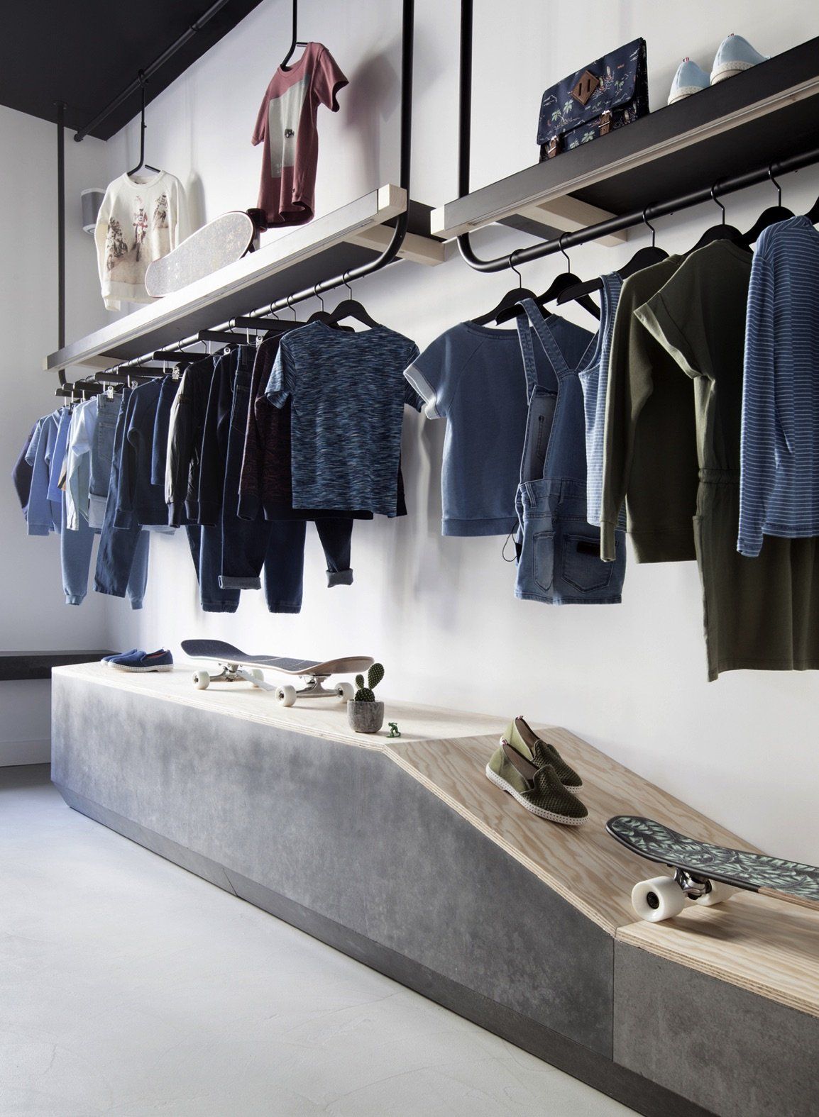a closet filled with clothes and skateboards on display