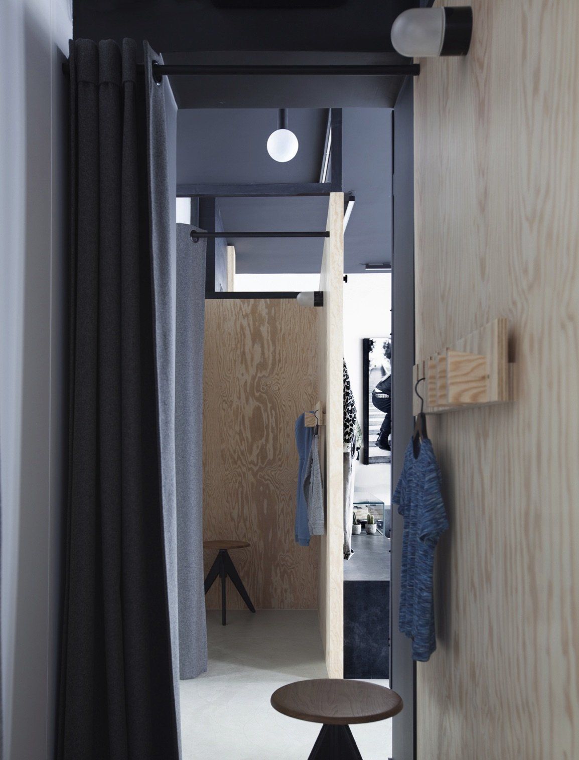 a dressing room with curtains and a stool