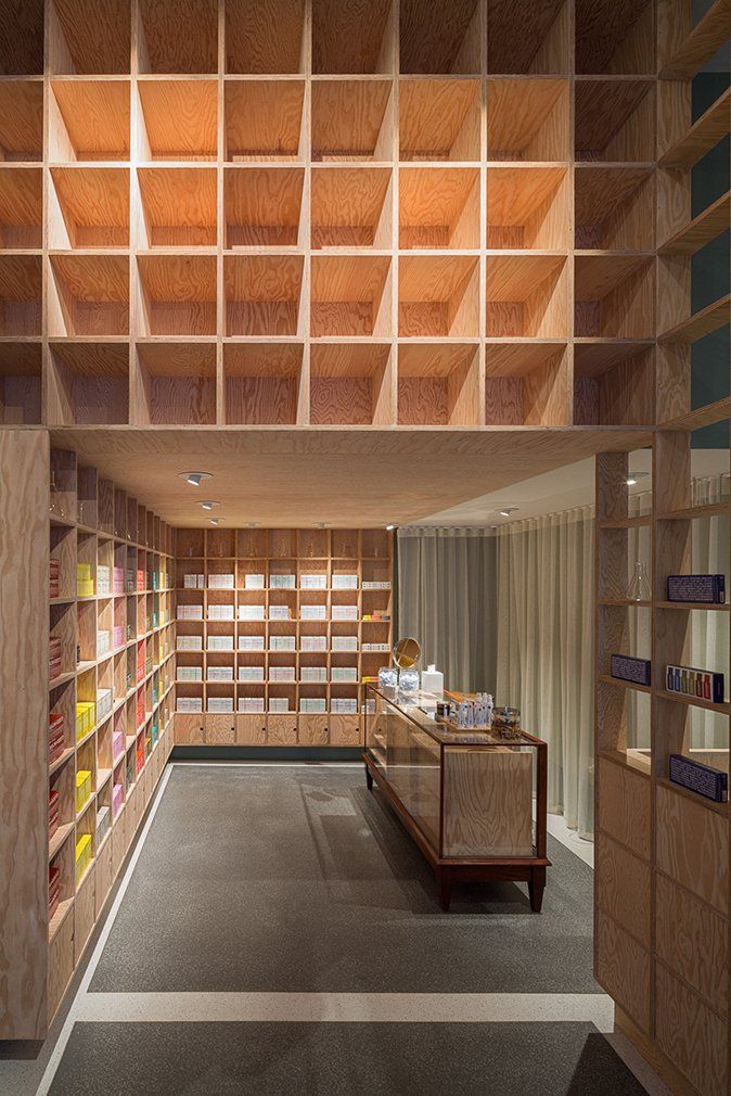 a store with lots of wooden shelves and a counter .