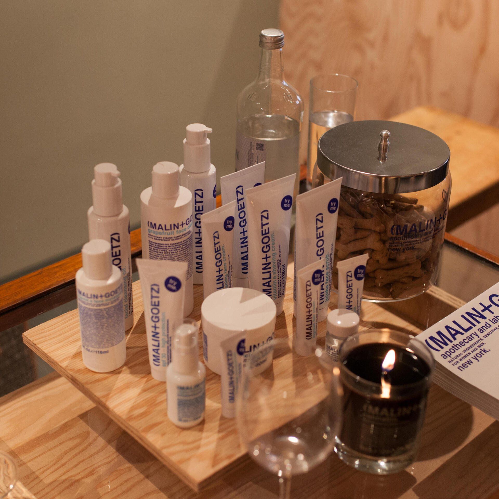 a wooden tray filled with bottles and tubes including one that says malinco