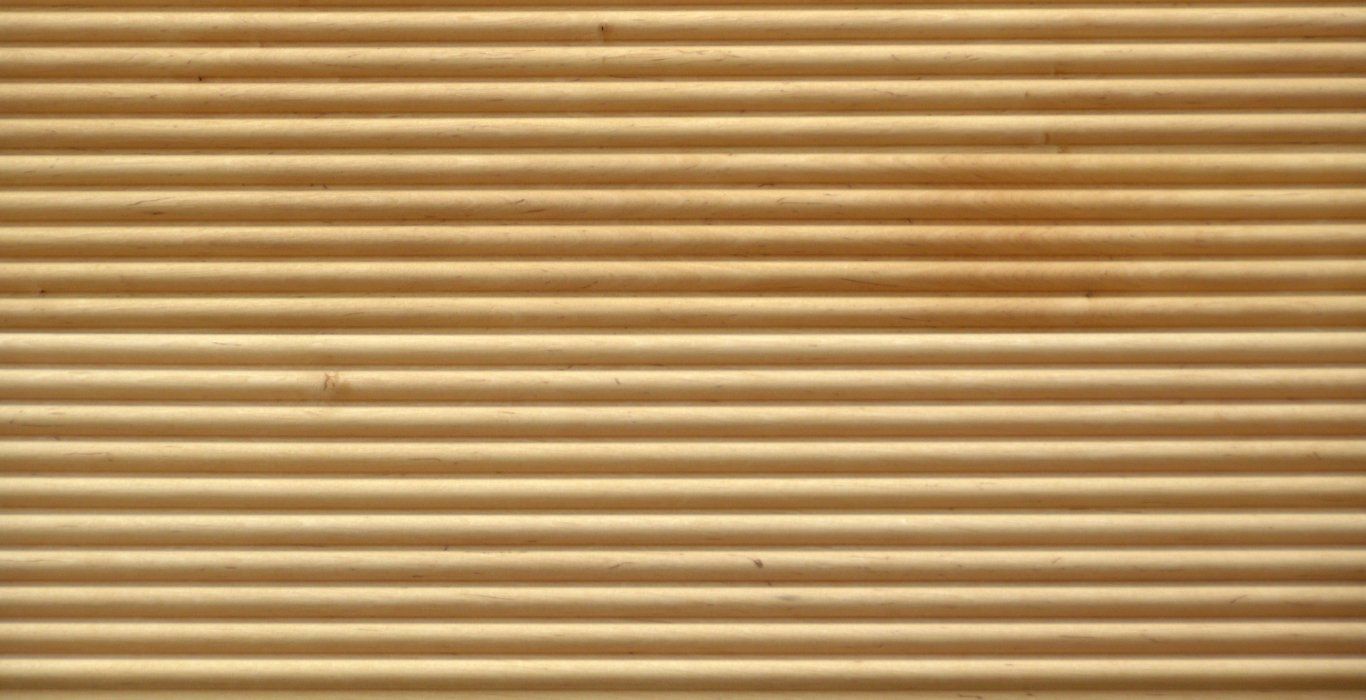 a close up of a corrugated cardboard wall texture .