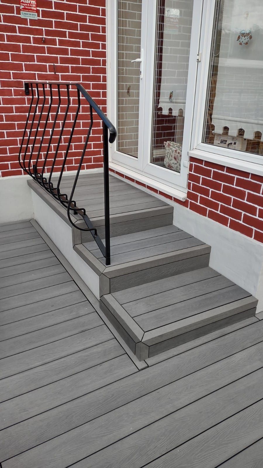 a set of stairs leading up to a brick building with a railing .