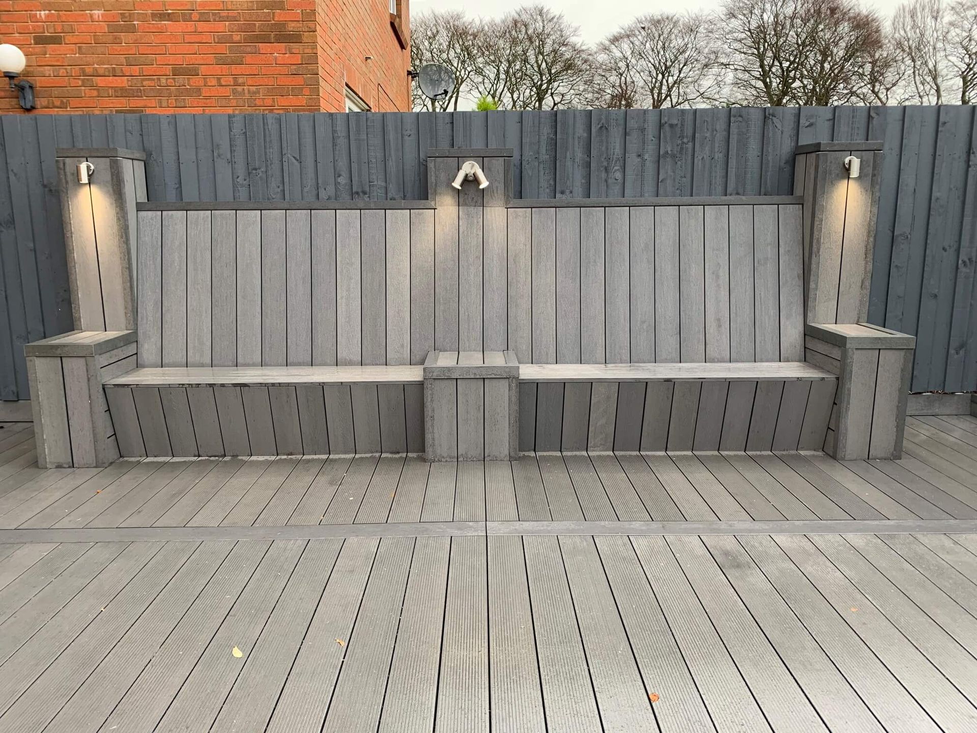 a wooden bench is sitting on top of a wooden deck .