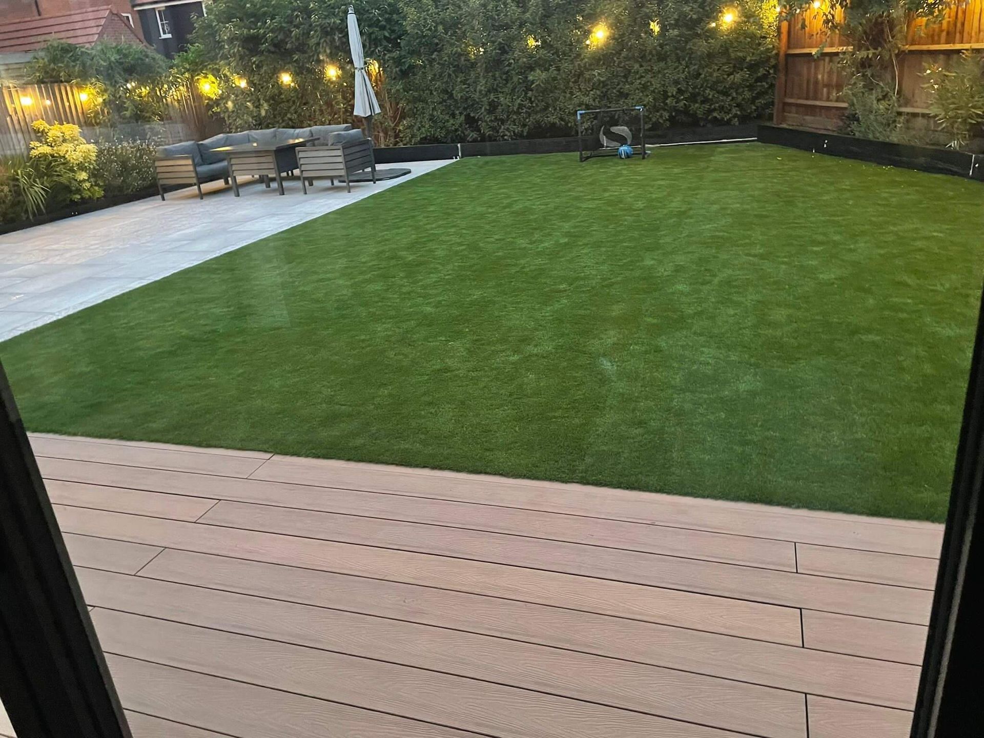 a view of a lush green lawn from a deck .