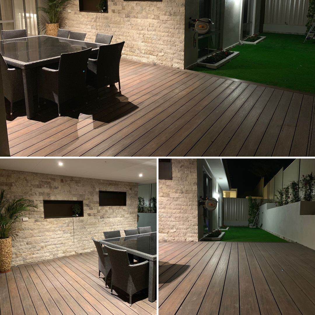 a wooden deck with a table and chairs on it