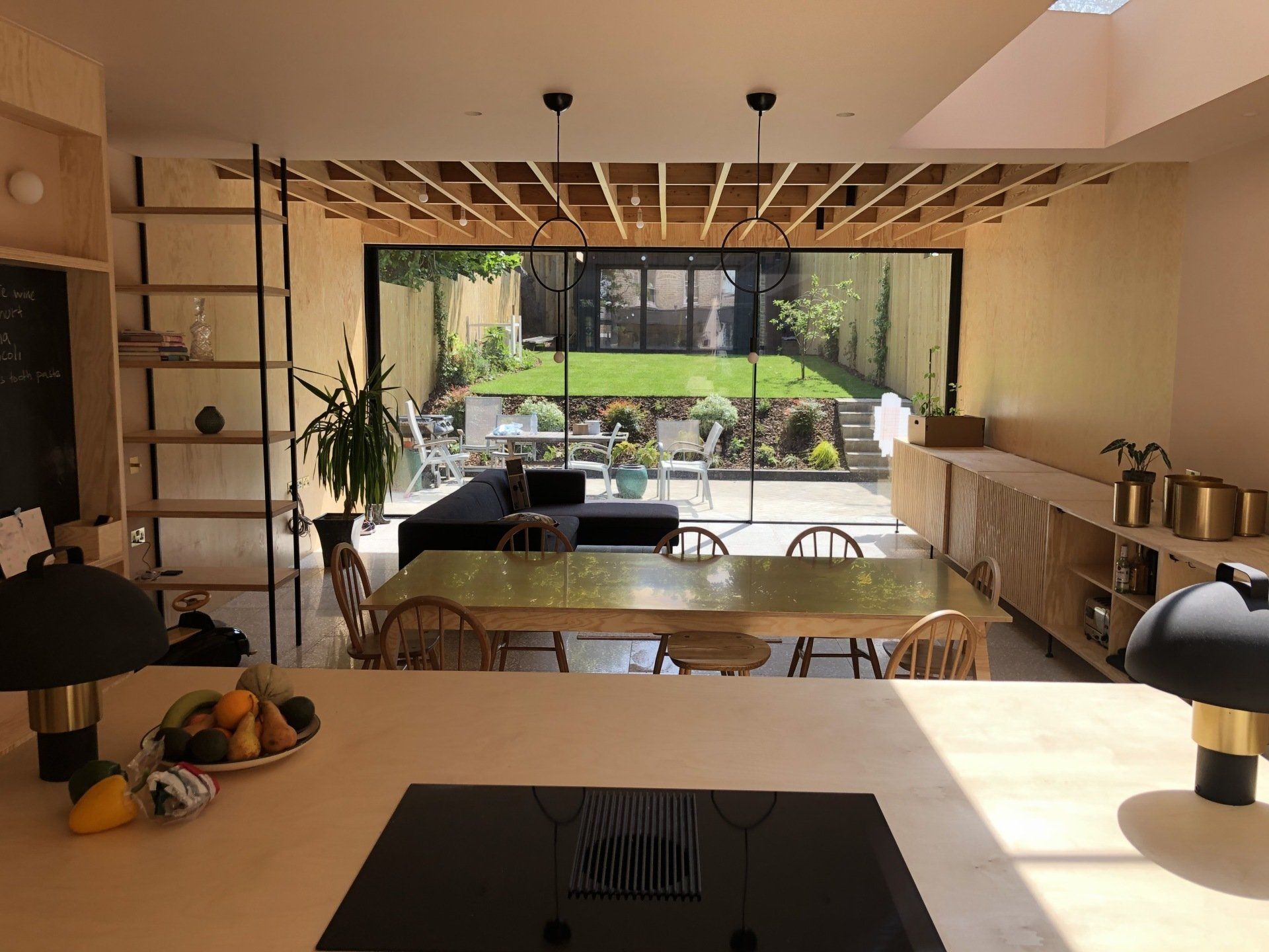 a kitchen with a table and chairs and a stove top oven .