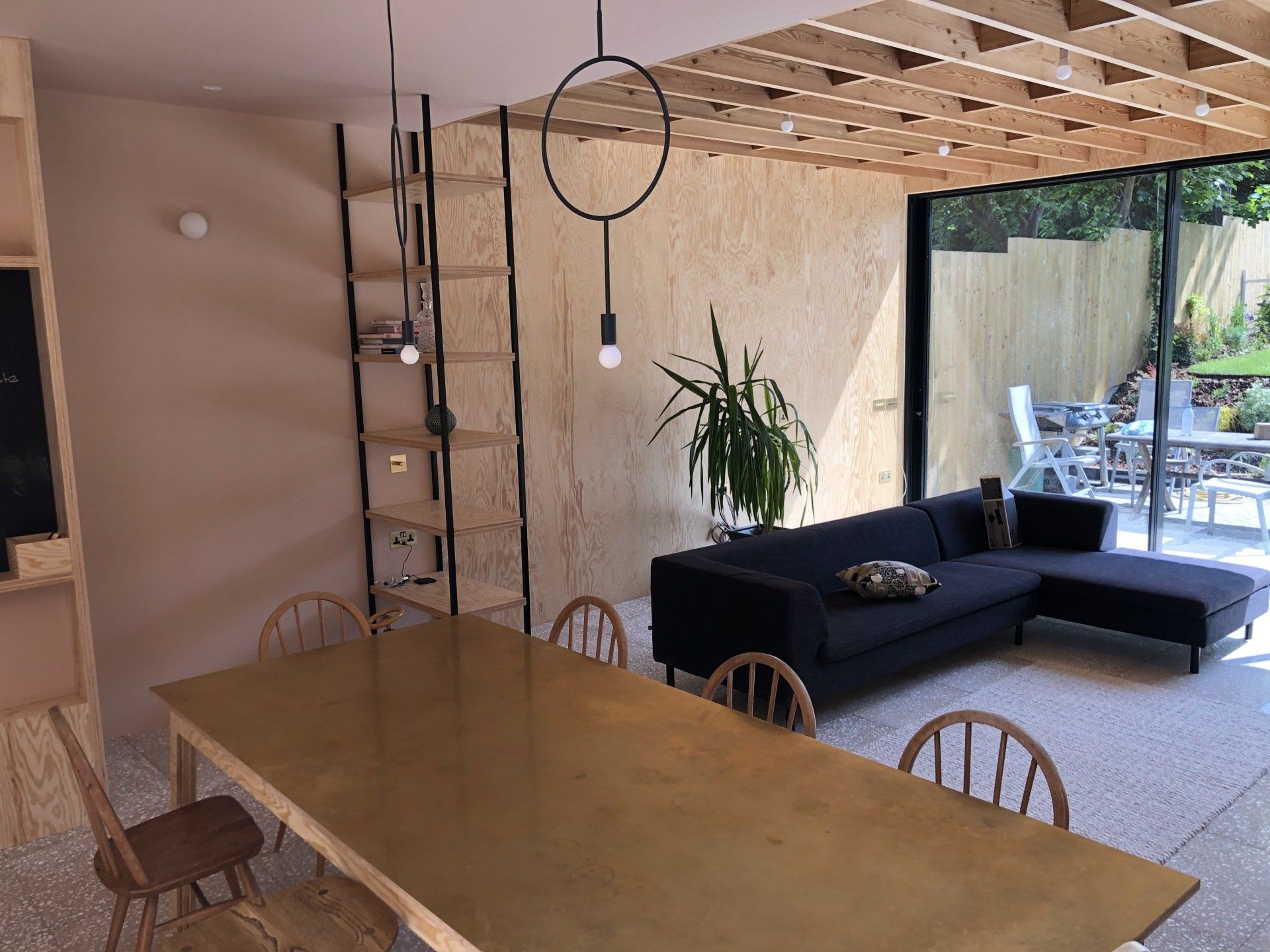 a living room with a couch , table and chairs .