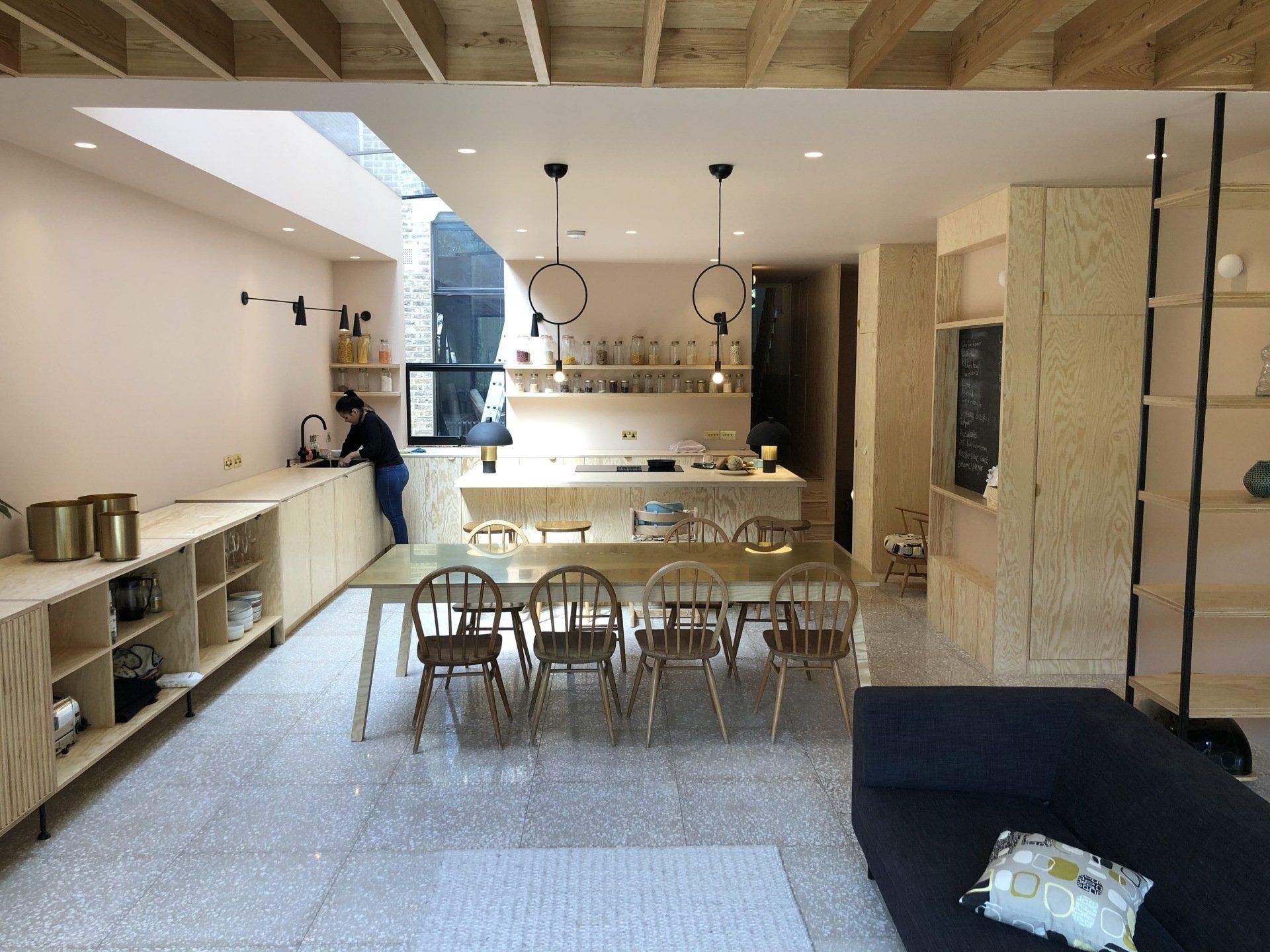 a kitchen with a table and chairs and a couch