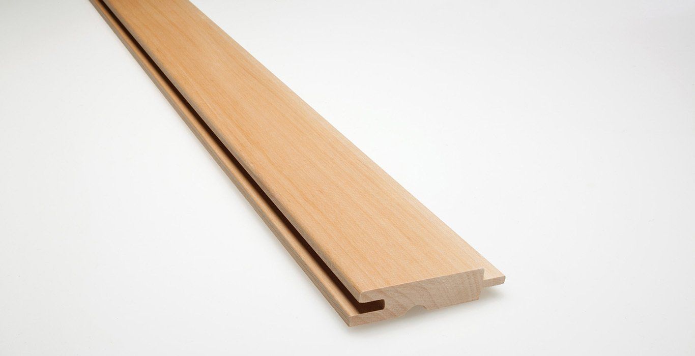 a piece of wood is sitting on a white surface .