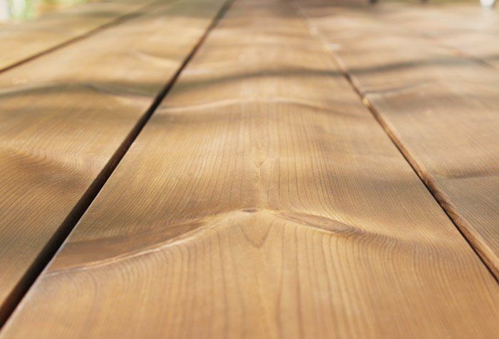 a close up of a wooden table with a lot of grain .