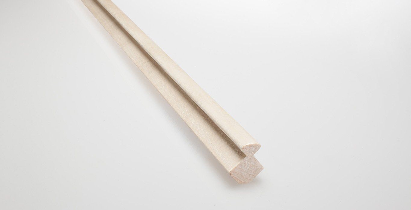 a piece of wood is sitting on a white surface .