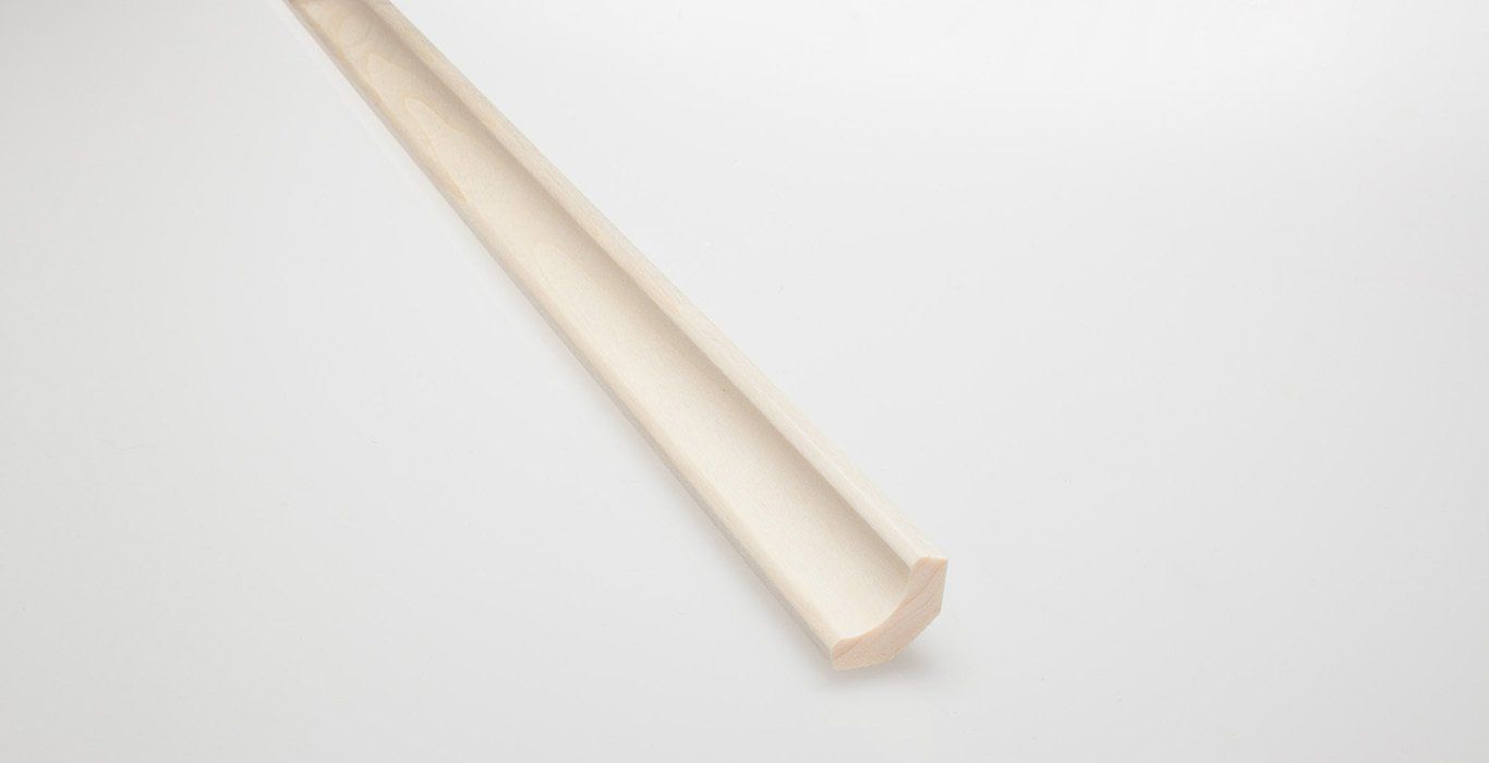 a white wooden stick is sitting on a white surface .