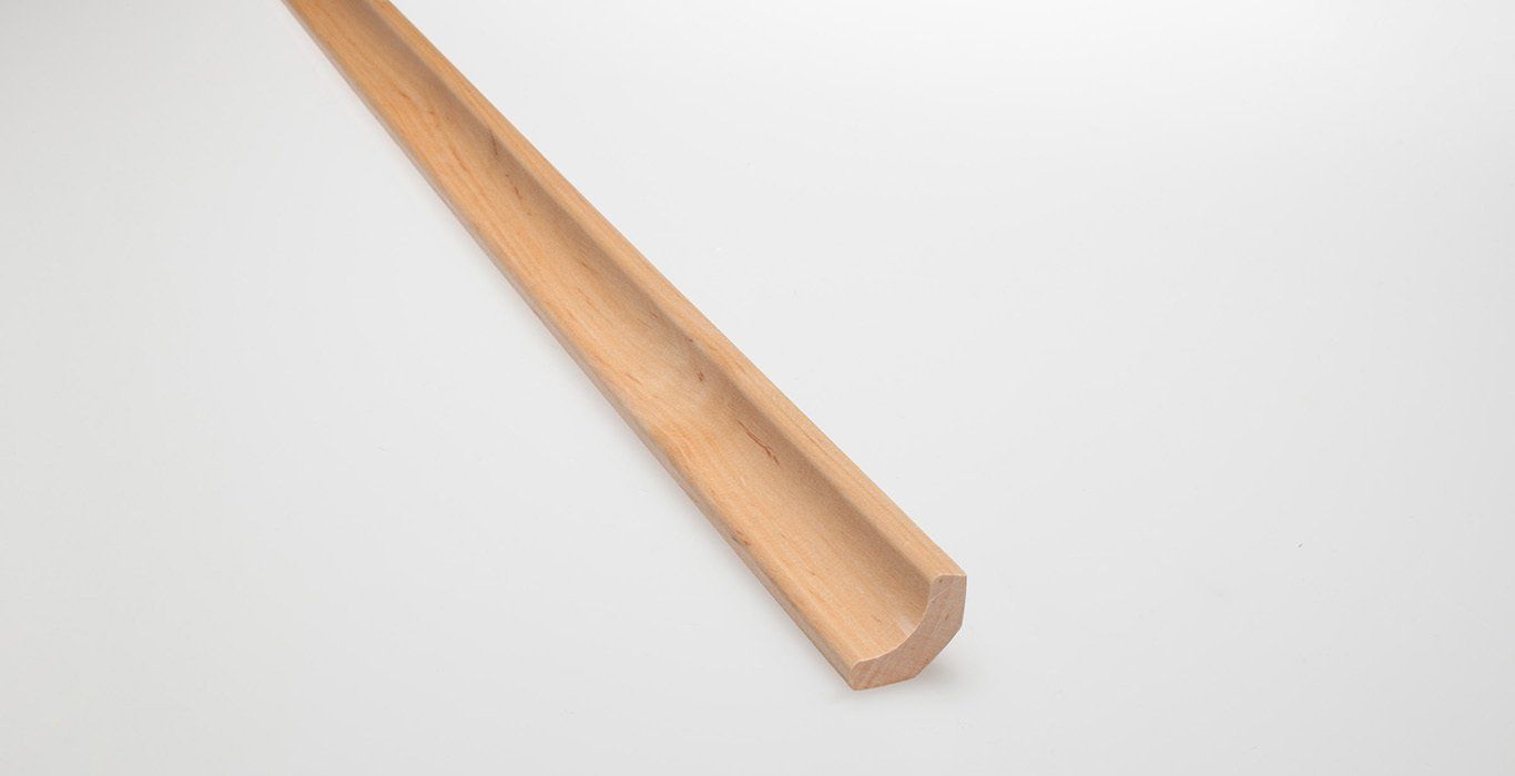 a wooden stick is sitting on a white surface .