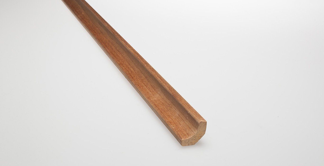 a wooden stick is sitting on a white surface .