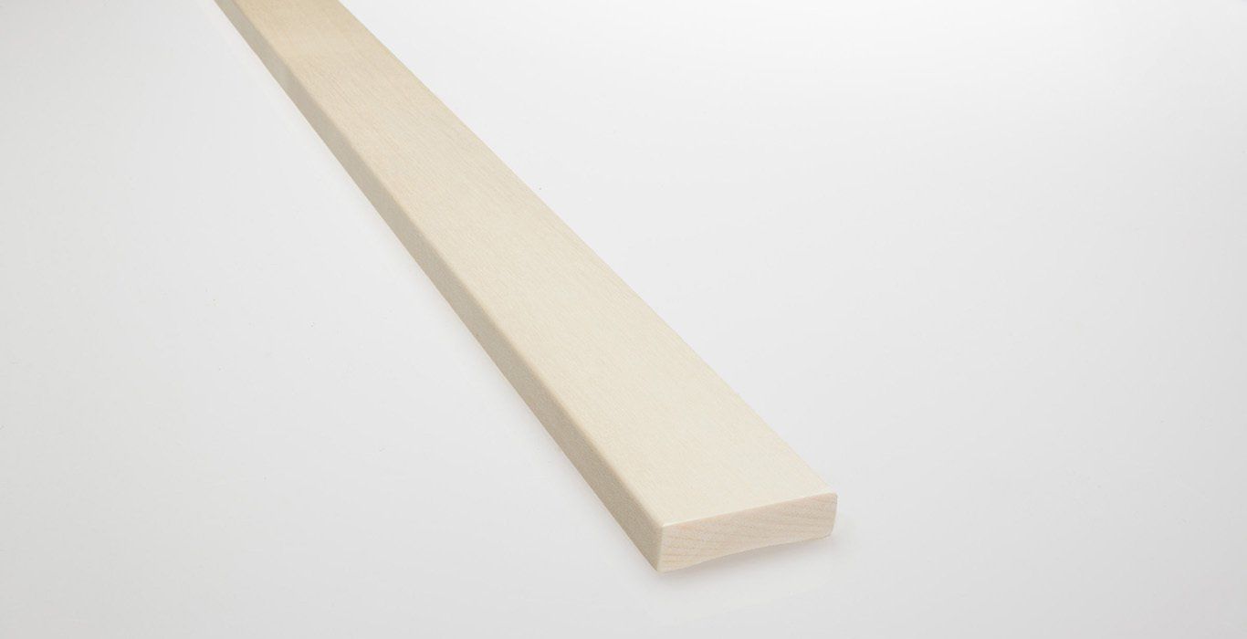 a white wooden plank is sitting on a white surface .