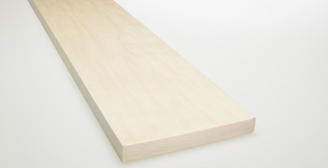 a piece of wood is sitting on a white surface .