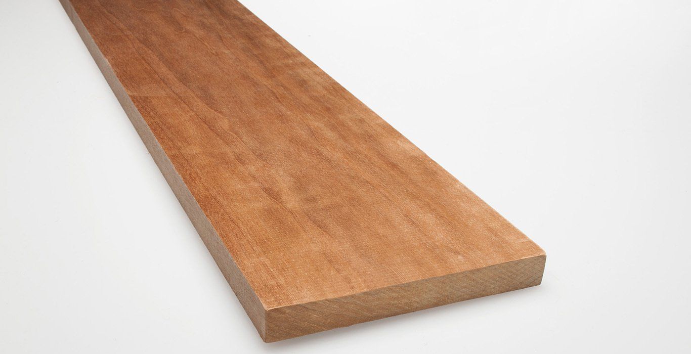 a piece of wood is sitting on a white surface .