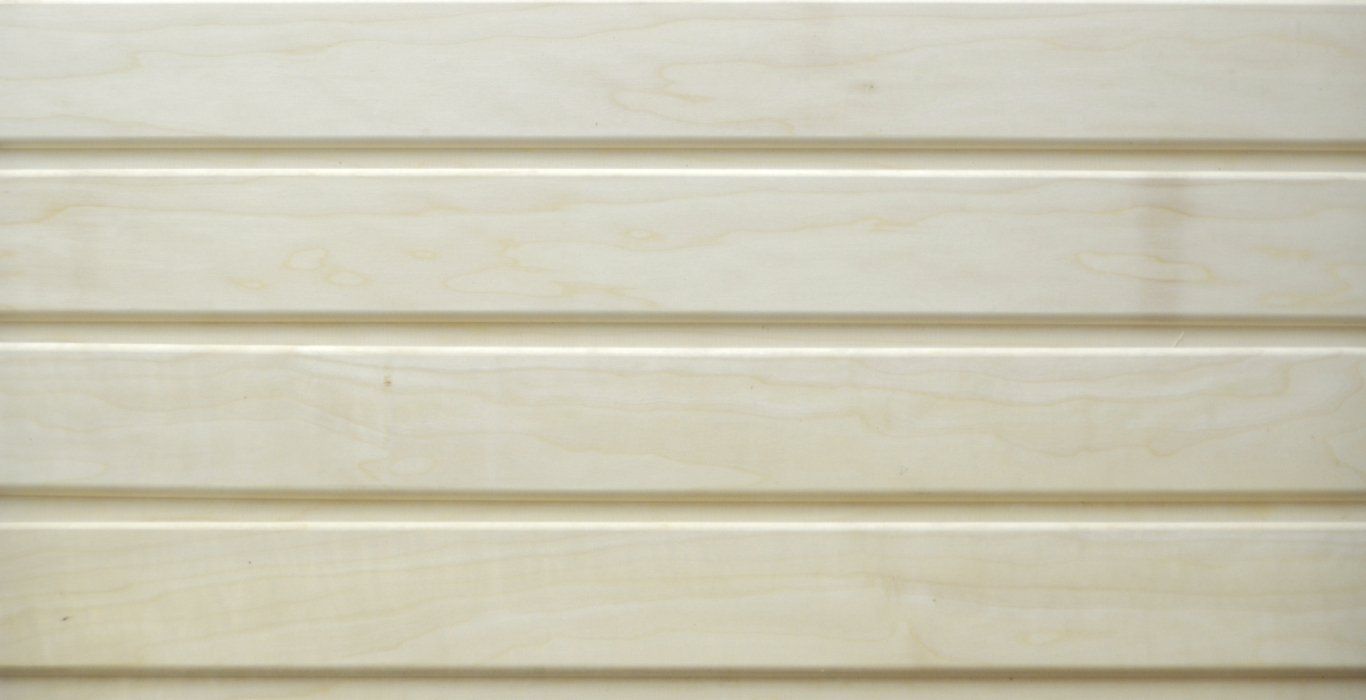 a close up of a white wooden siding on a wall .