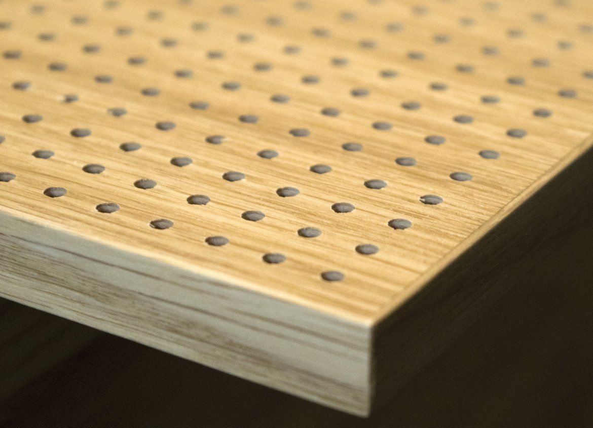 a close up of a piece of wood with holes in it .