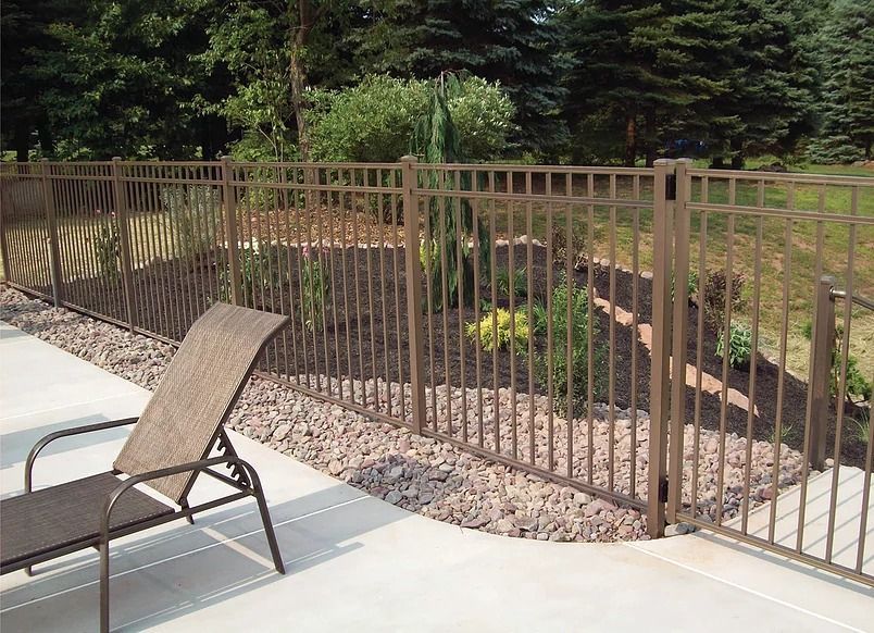 A chair is sitting on a patio next to a fence.