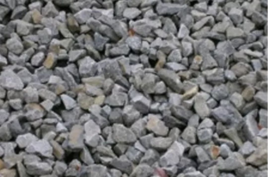 A pile of gravel is sitting on the ground.