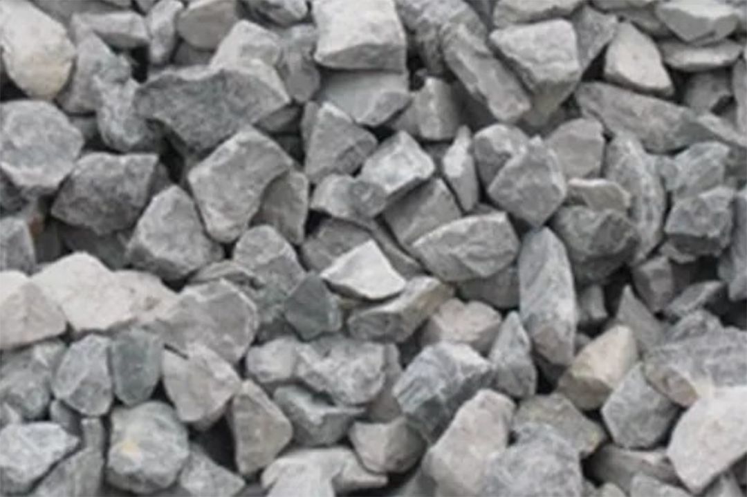 A pile of rocks is sitting on the ground.