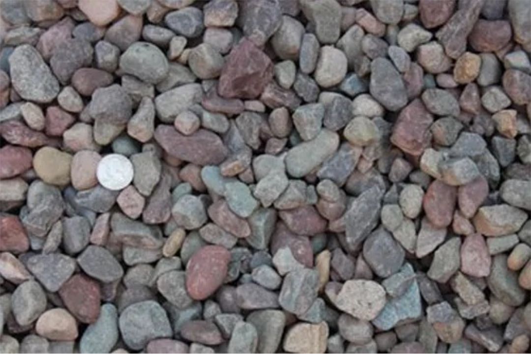 A pile of rocks with a coin in the middle.