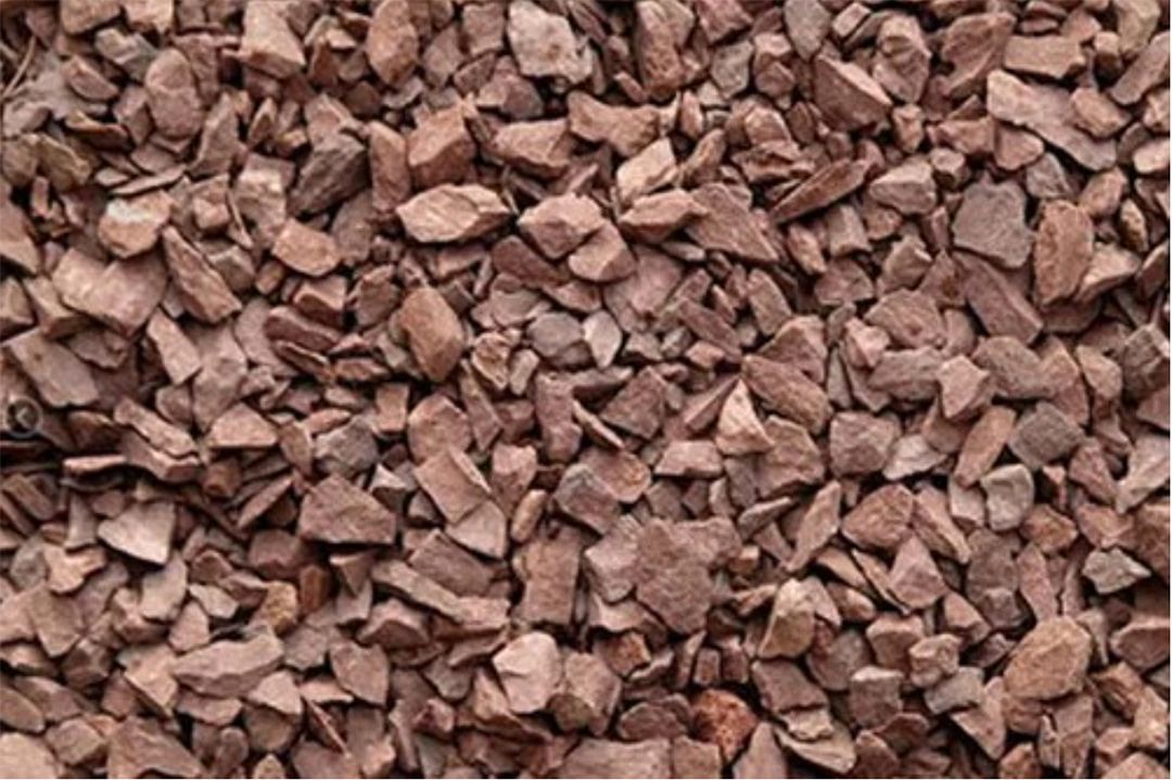 A pile of brown gravel is sitting on top of each other.