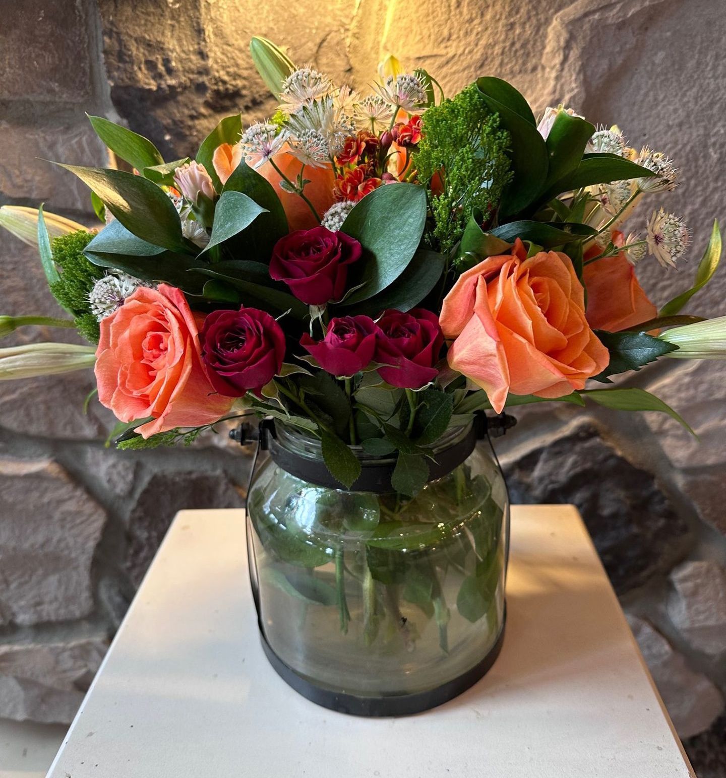 A vase filled with flowers is sitting on a table.