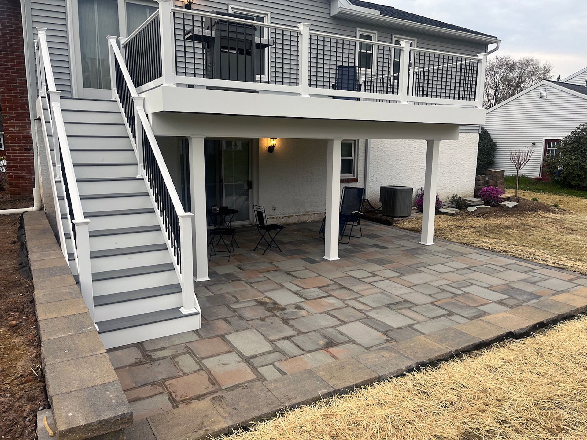 A house with a large deck and stairs leading up to it.