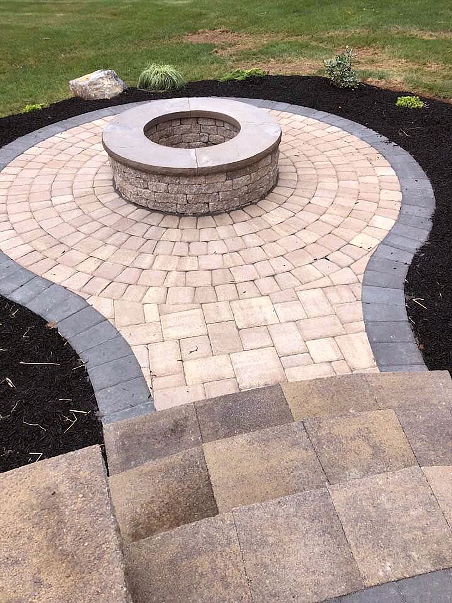 There is a fire pit in the middle of the patio.