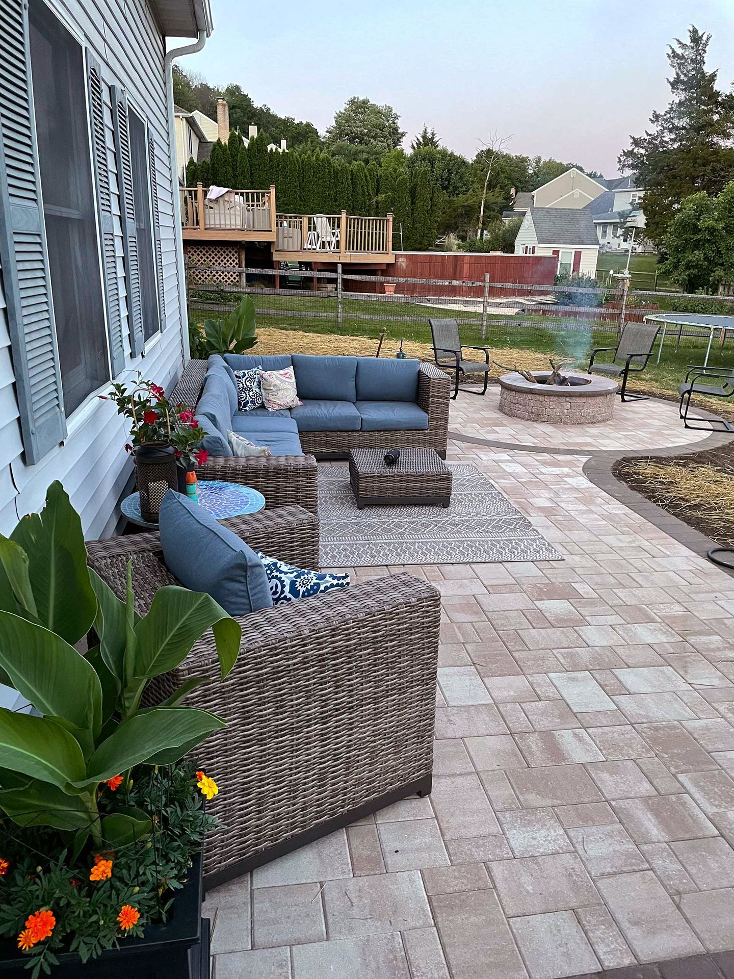 There is a fire pit in the middle of the patio.