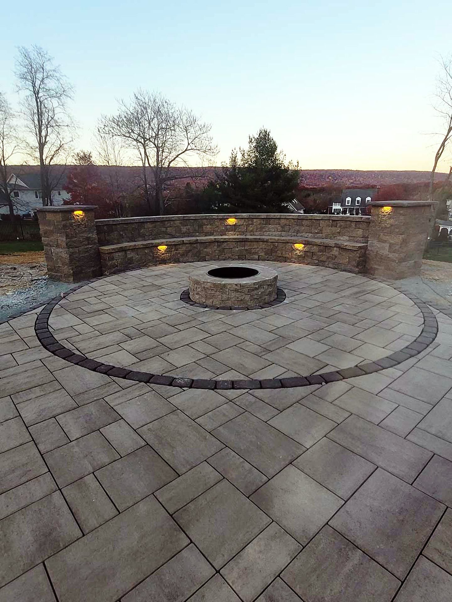 There is a fire pit in the middle of the patio.