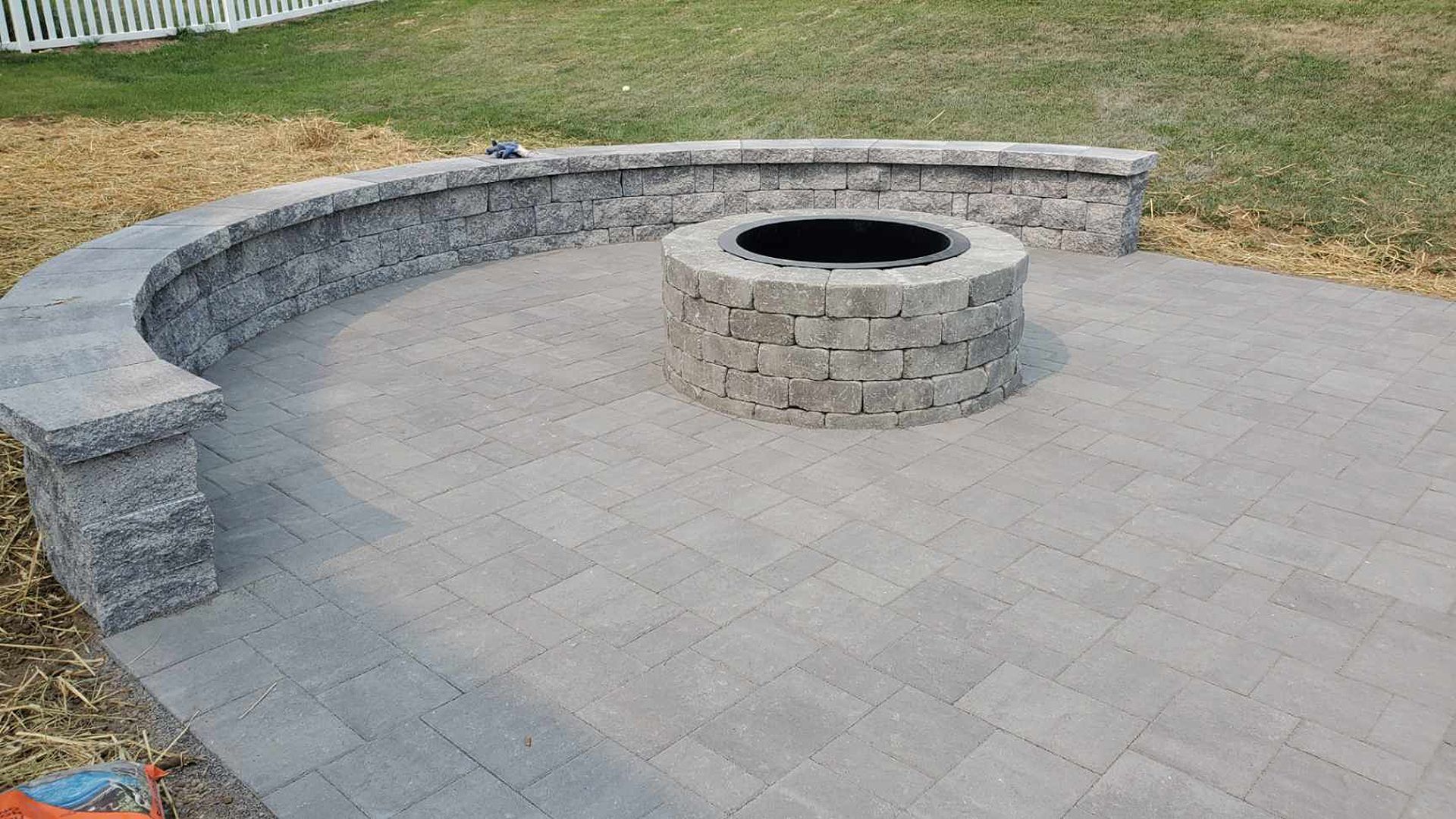 There is a fire pit in the middle of the patio.